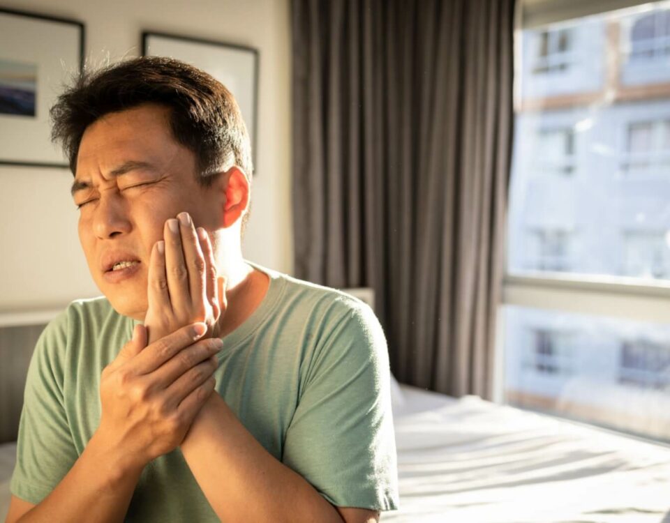 A person holding their jaw in pain