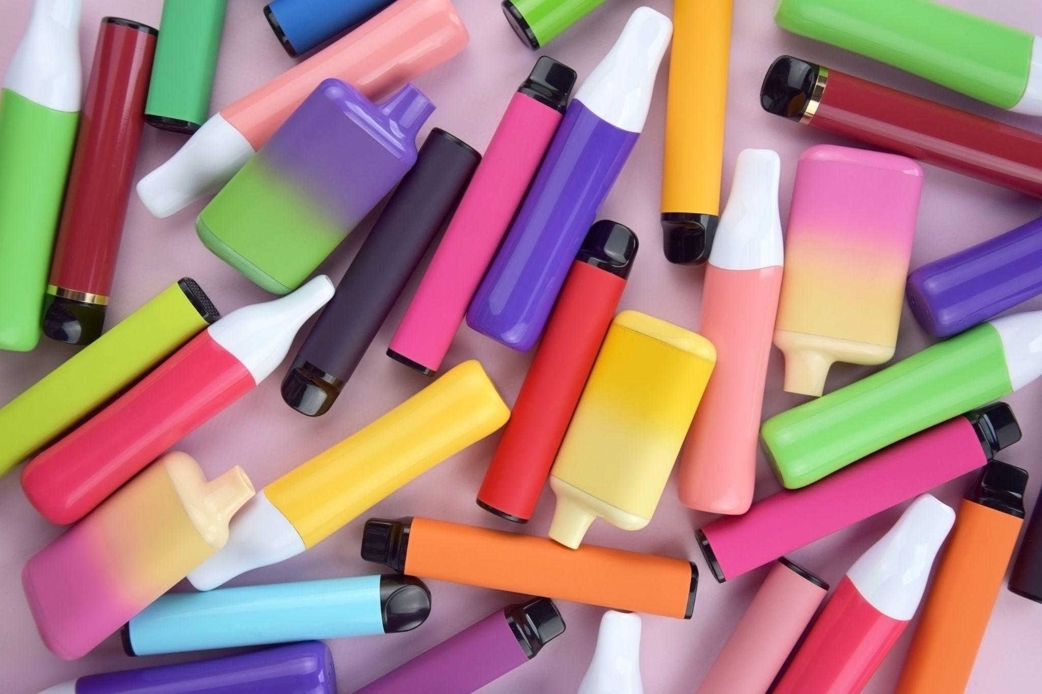 Various colourful vapes on aa desk